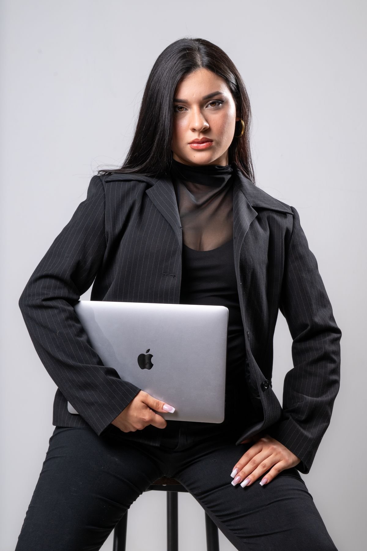 Retrato sentada con traje y portátil
